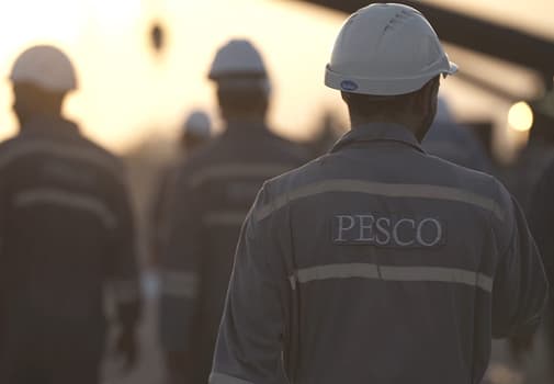 PESCO crew walking a site at sunset