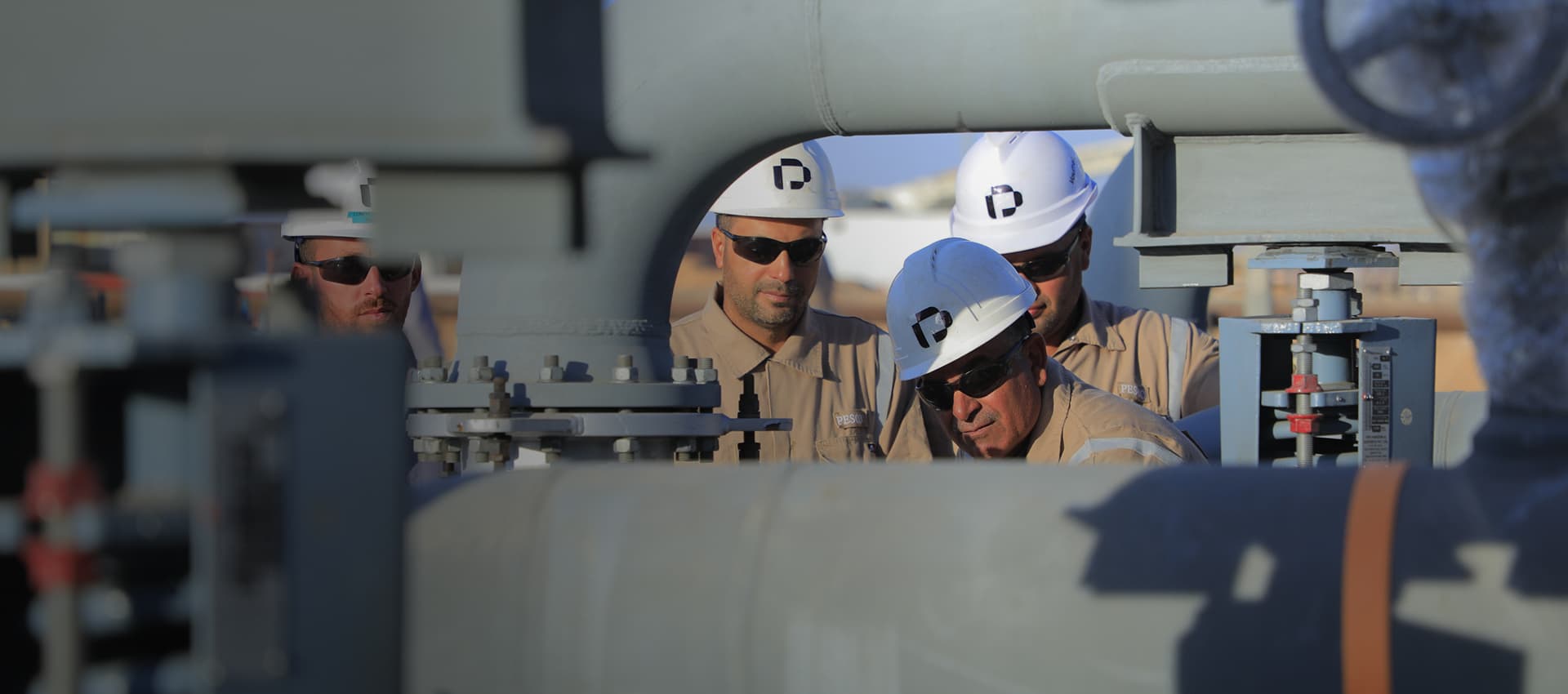 PESCO engineers inspecting pipework on an oil and gas facility