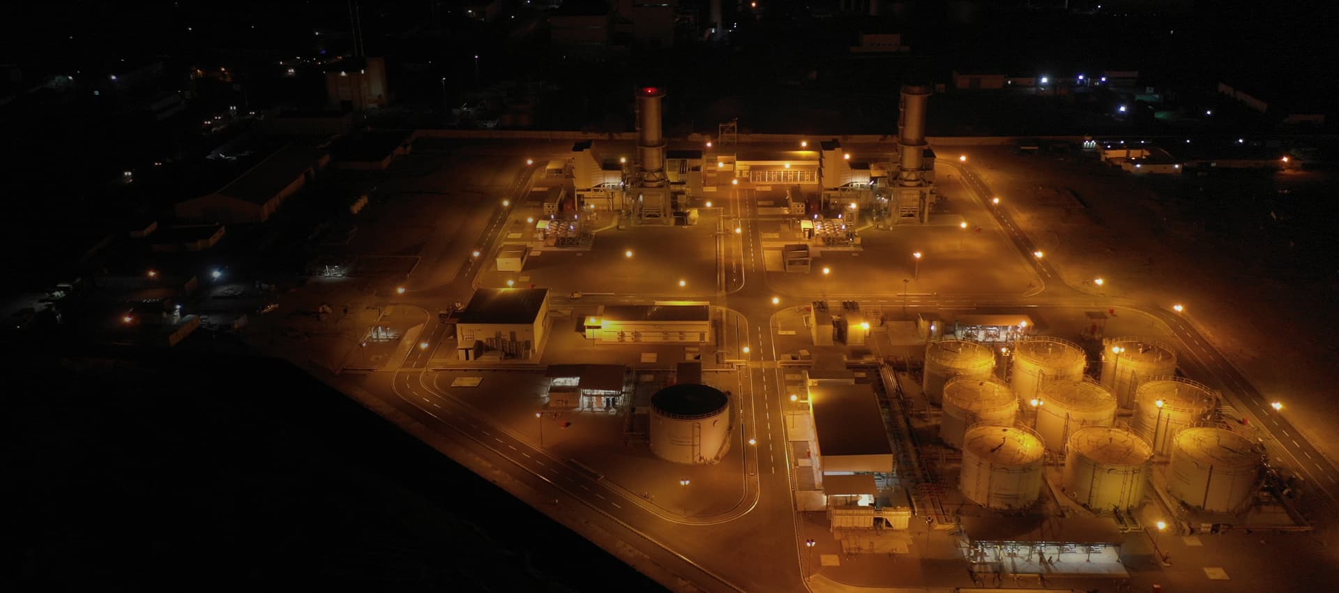 Aerial view of a power and storage facility lit up at night