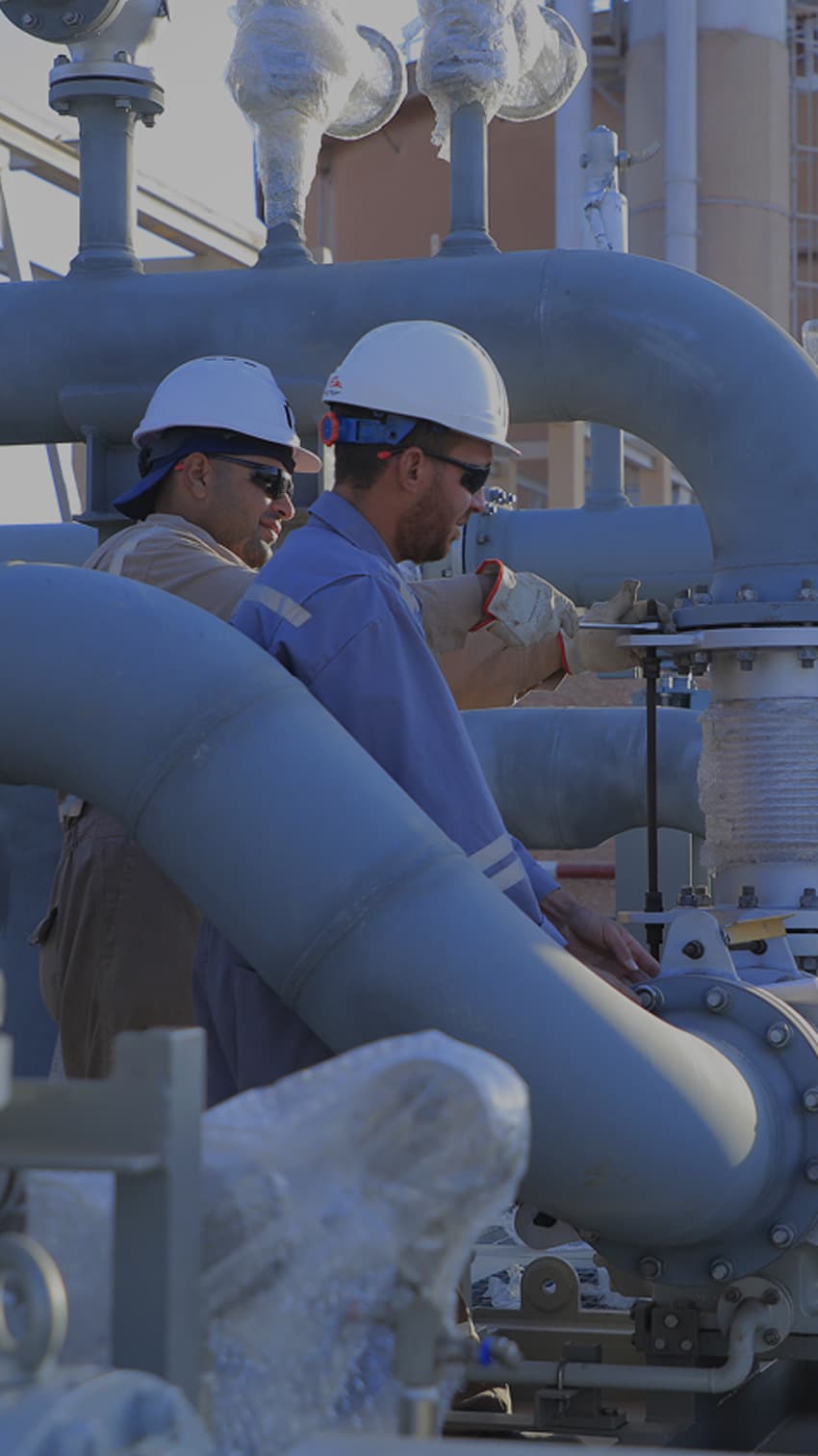 PESCO engineers inspecting a wellhead manifold