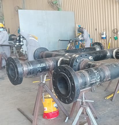 Flanged piping spools on stands in the fabrication shop