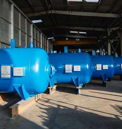 Blue pressure vessels lined up in the PESCO workshop