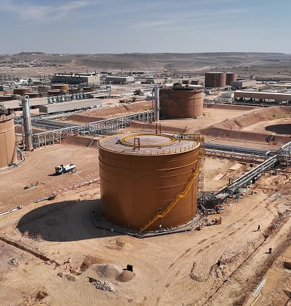 A large storage tank built on site at a desert processing plant