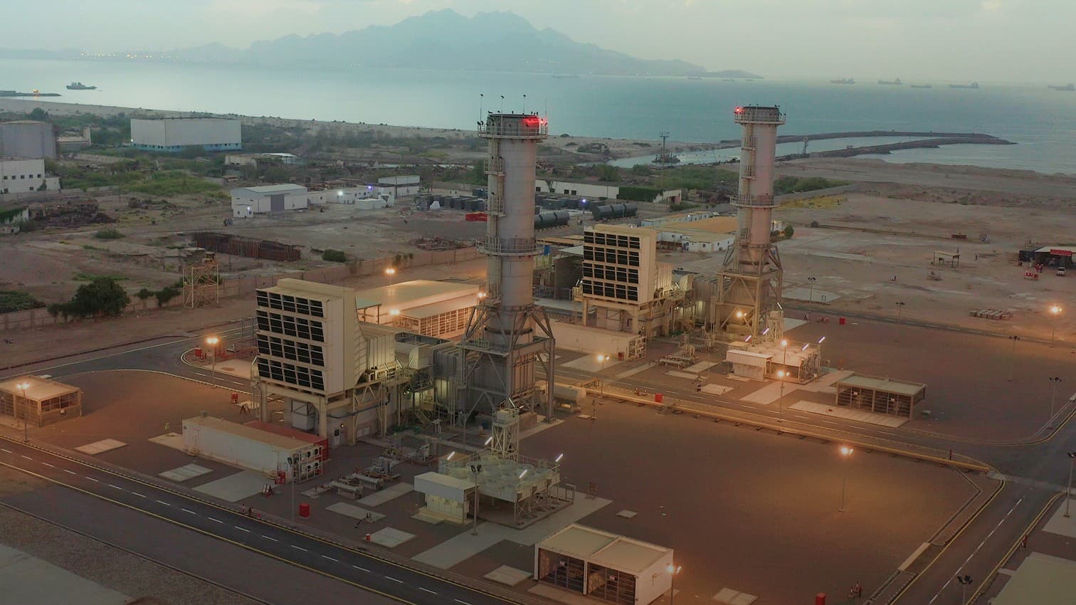 A PESCO-built combined cycle power plant on the coast at dusk